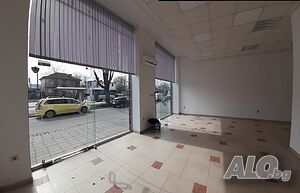 Магазин на оживен булевард, зад спирка